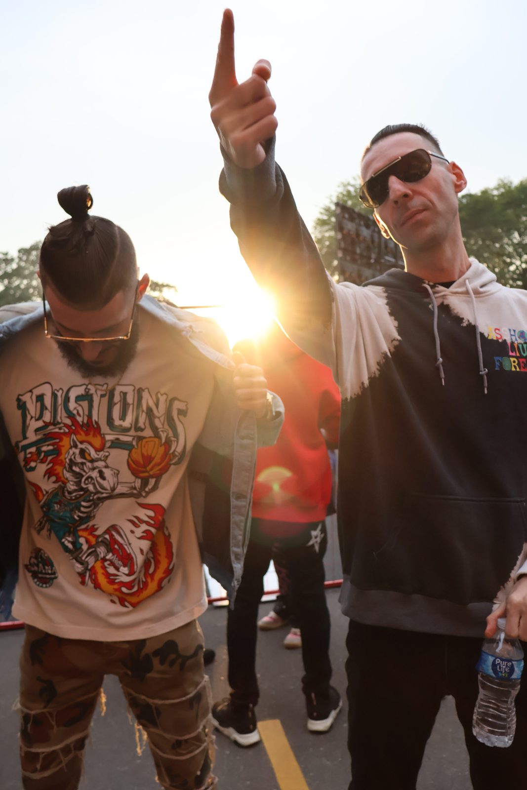 KING T and LUSS with hands up against the sunset