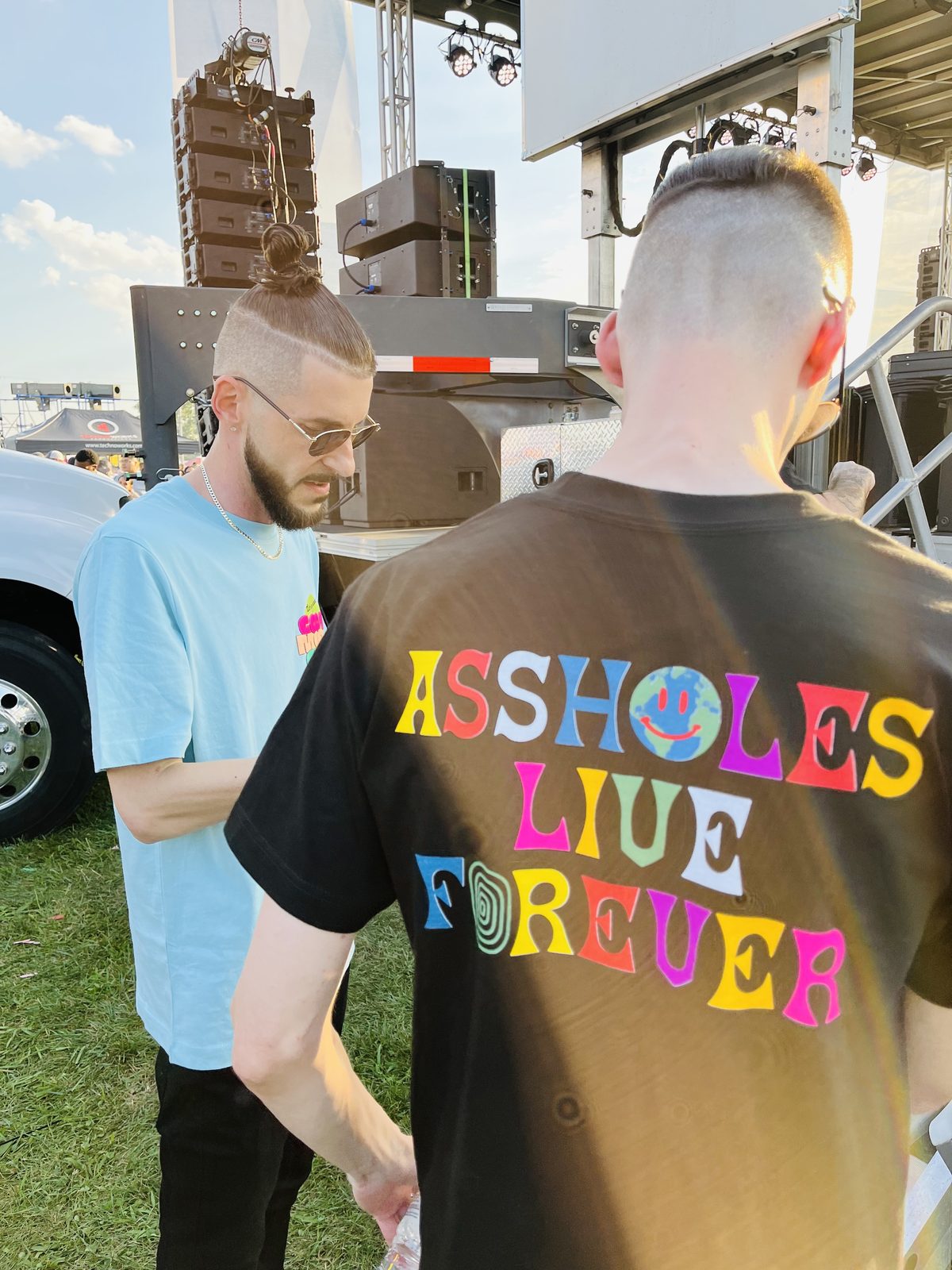 KING T from behind in a neon lettered tee