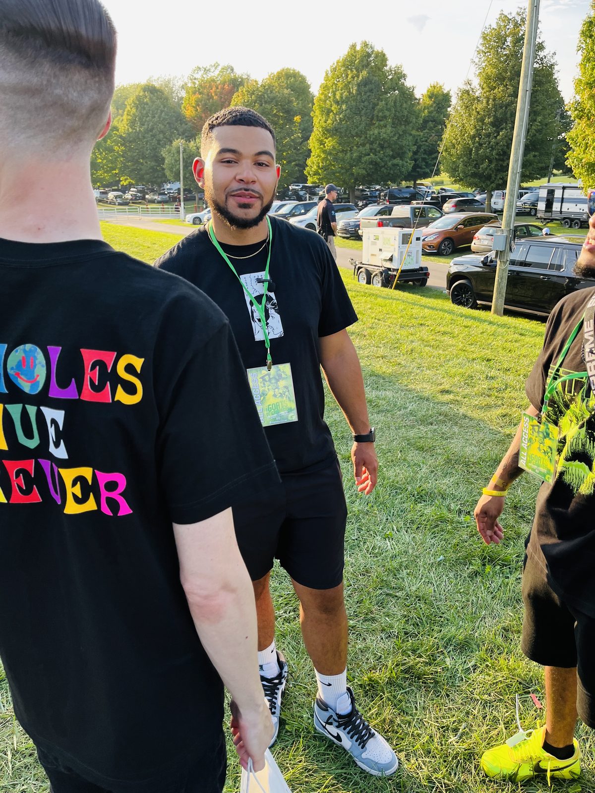 KING T in a colorful tee at a festival