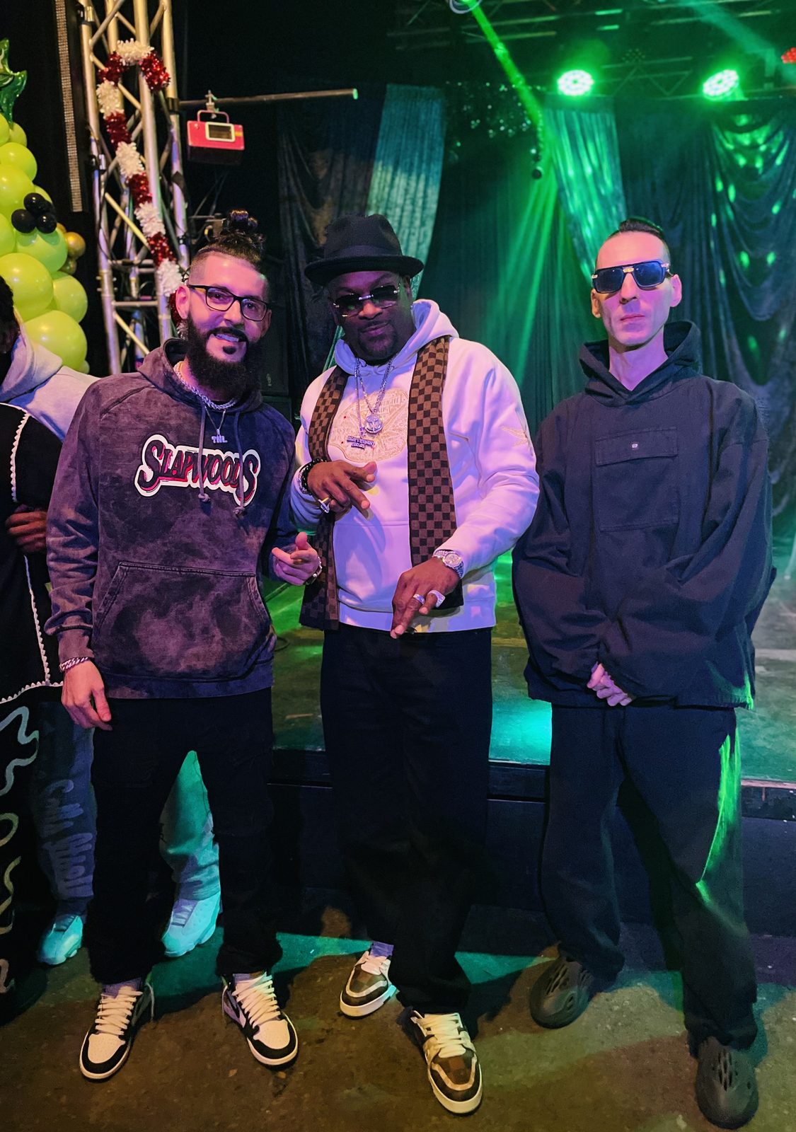 KING T and LUSS with Trick Trick on a stage under green lights