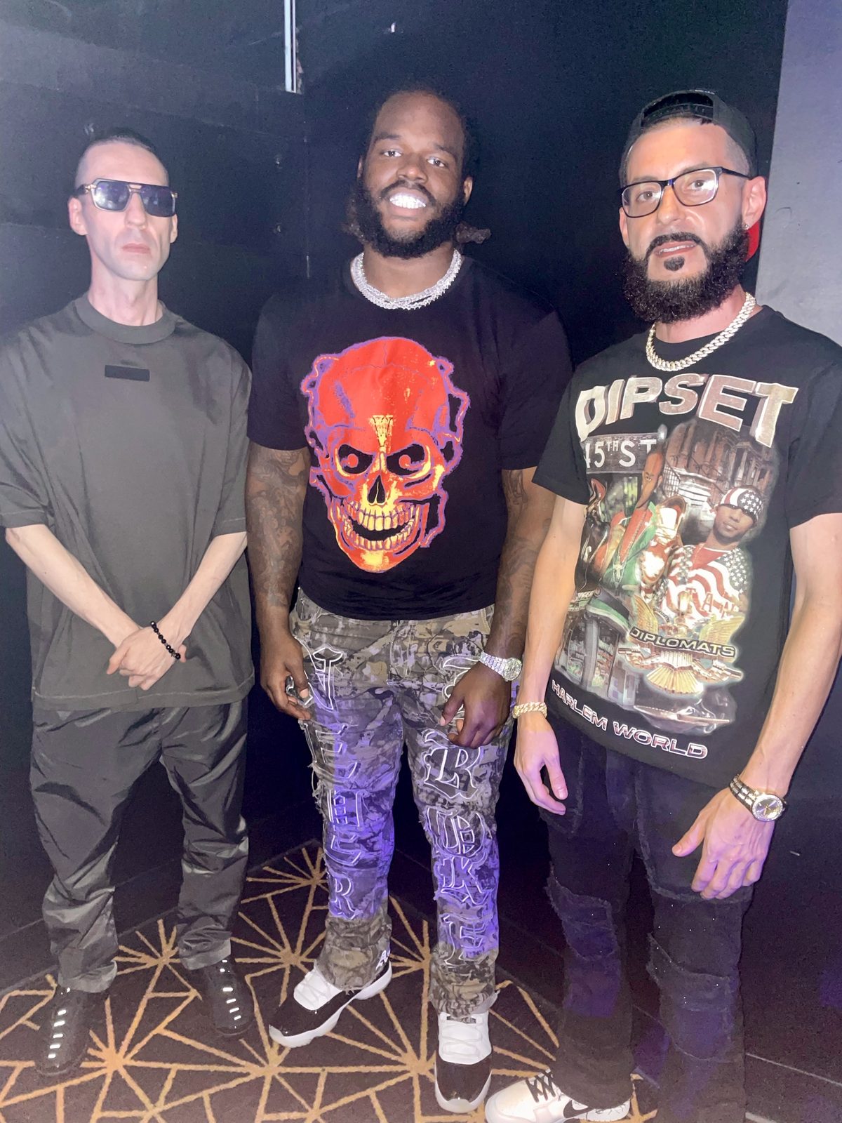 KING T and LUSS with Mazi Smith at a dark venue