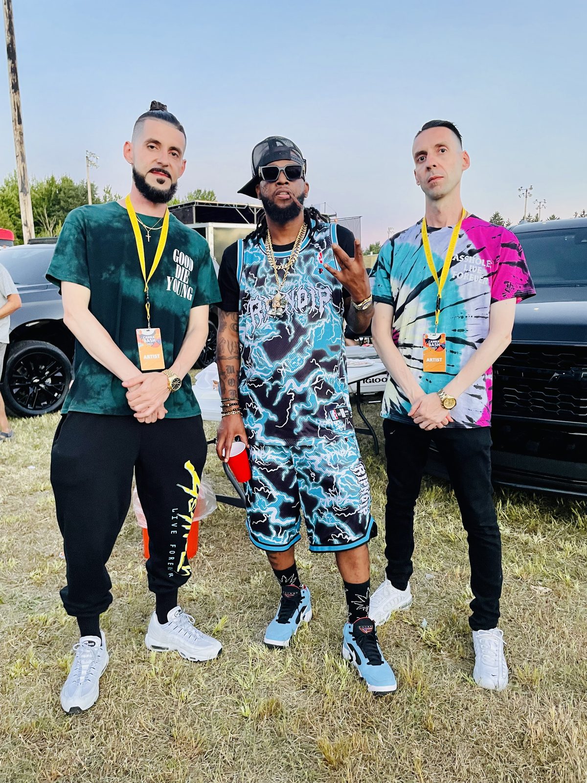 KING T and LUSS with Yukmouth on the grass at a festival