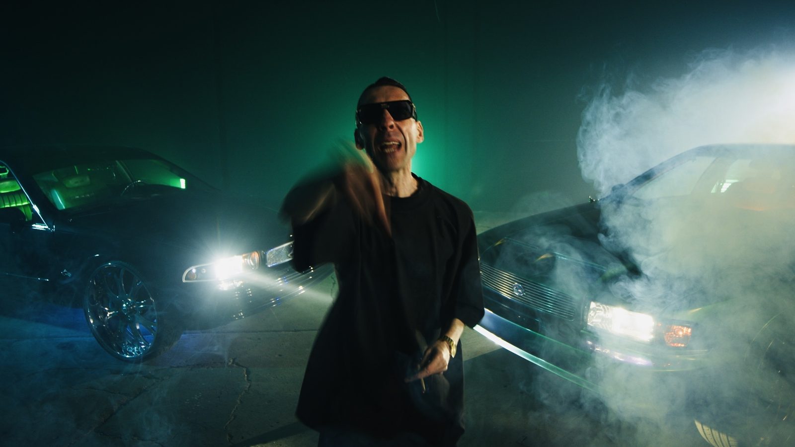 Two cars in smoke from a music video